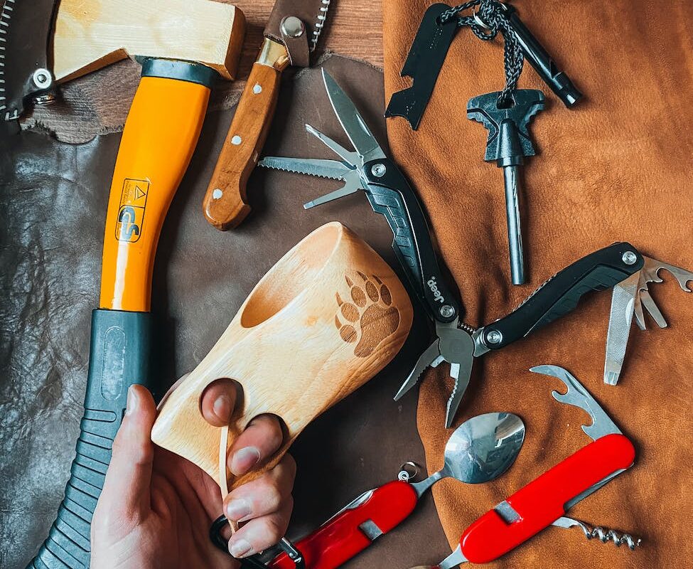 axe knife and swiss knives lying on floor