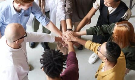 photo of people holding each other s hands