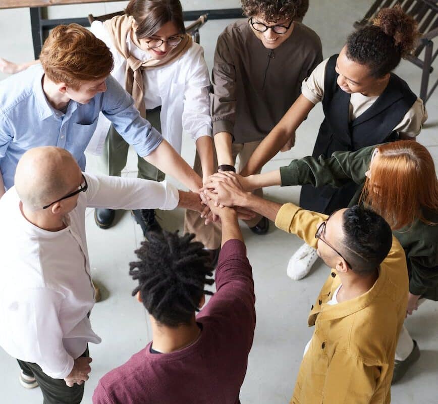 photo of people holding each other s hands