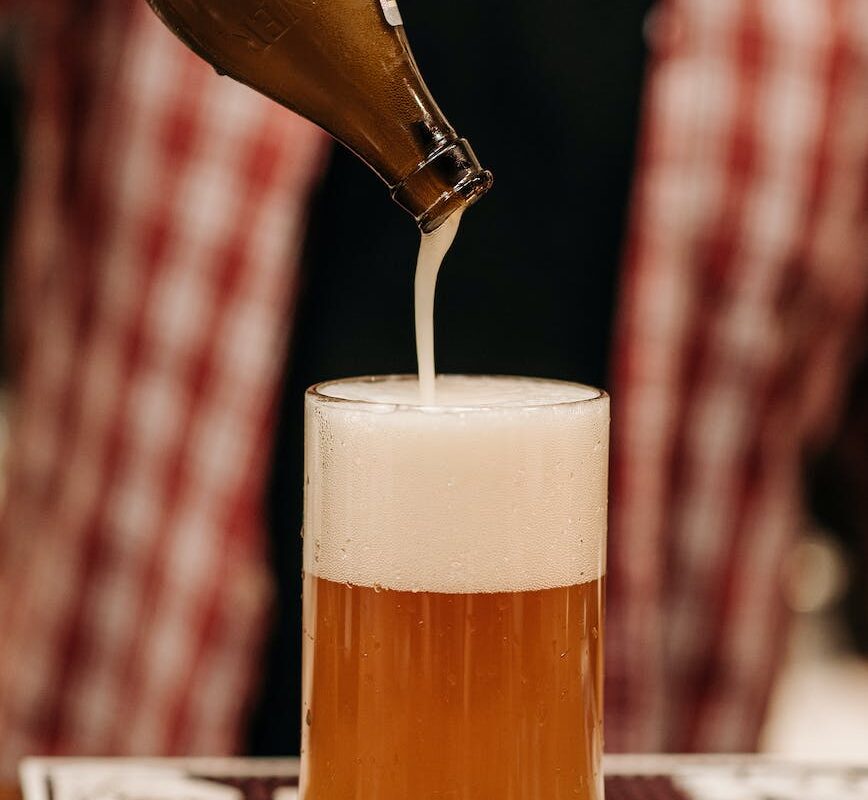 beer bottle on top of a beer glass