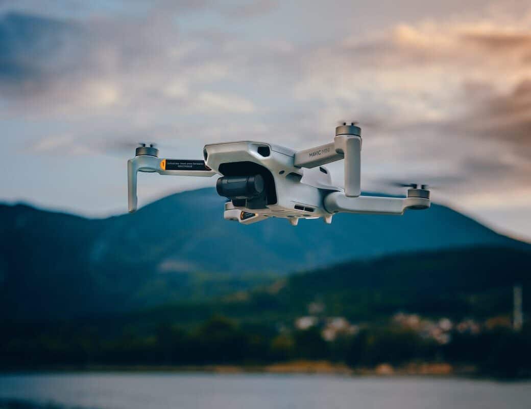 professional drone flying against mountains
