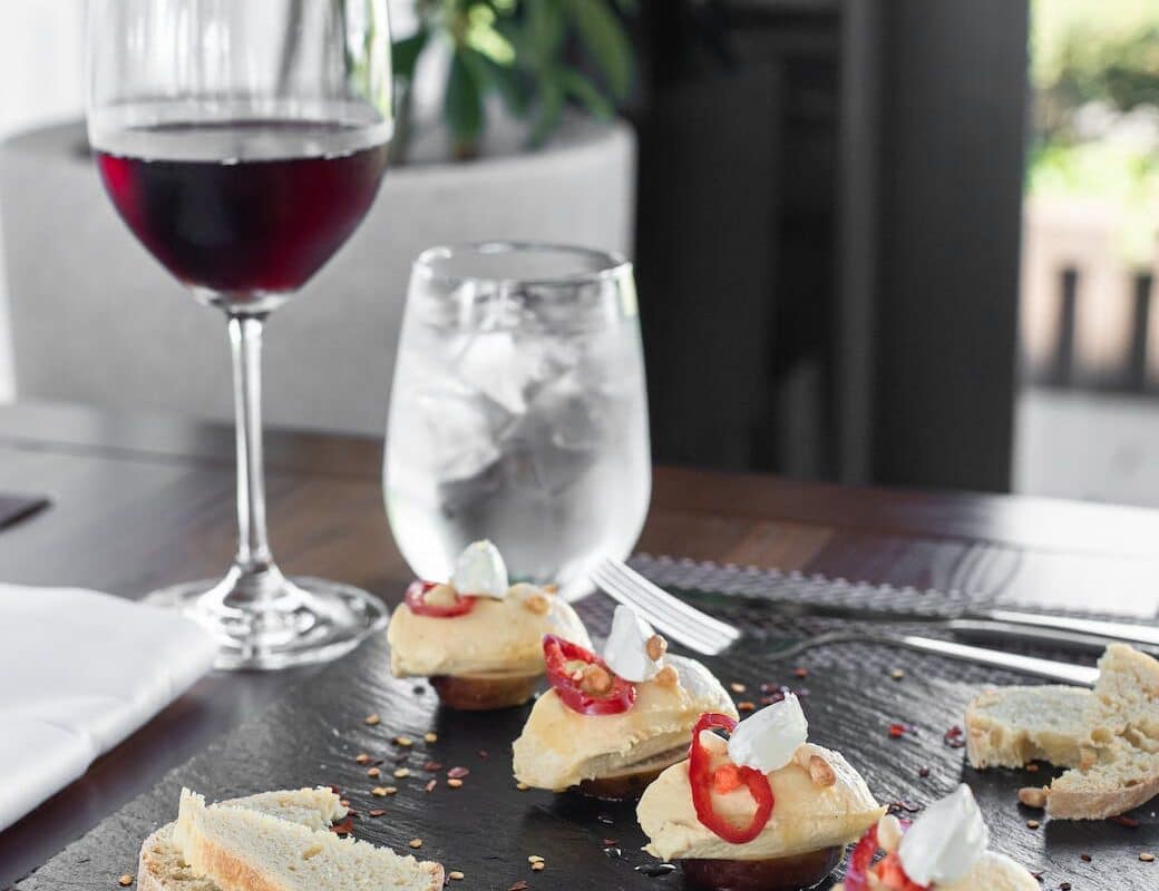 delicious food served on table with glass of red wine