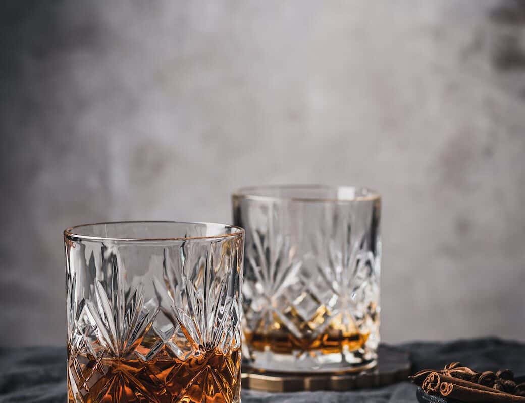 clear shot glass on black wooden table