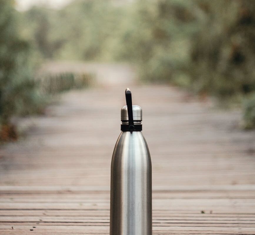 vacuum flask on brown wooden dock