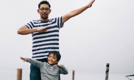 man and boy standing on bridge