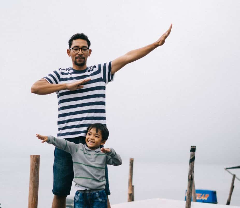 man and boy standing on bridge