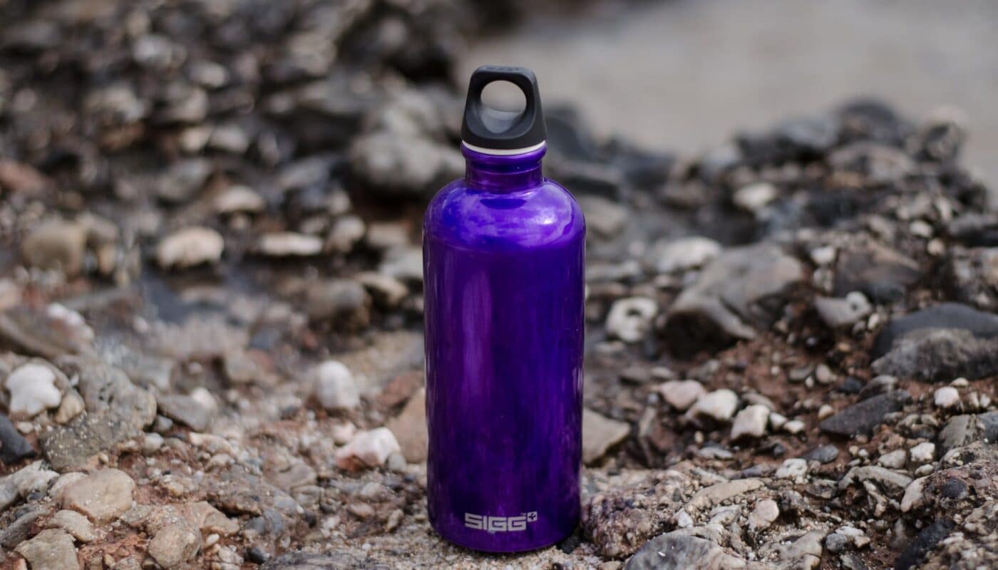 purple sports bottle on ground