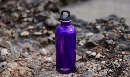purple sports bottle on ground