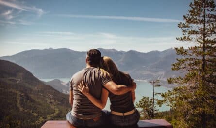 man and woman sitting on bench