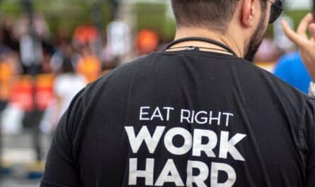 person wearing eat right work hard feel good printed shirt