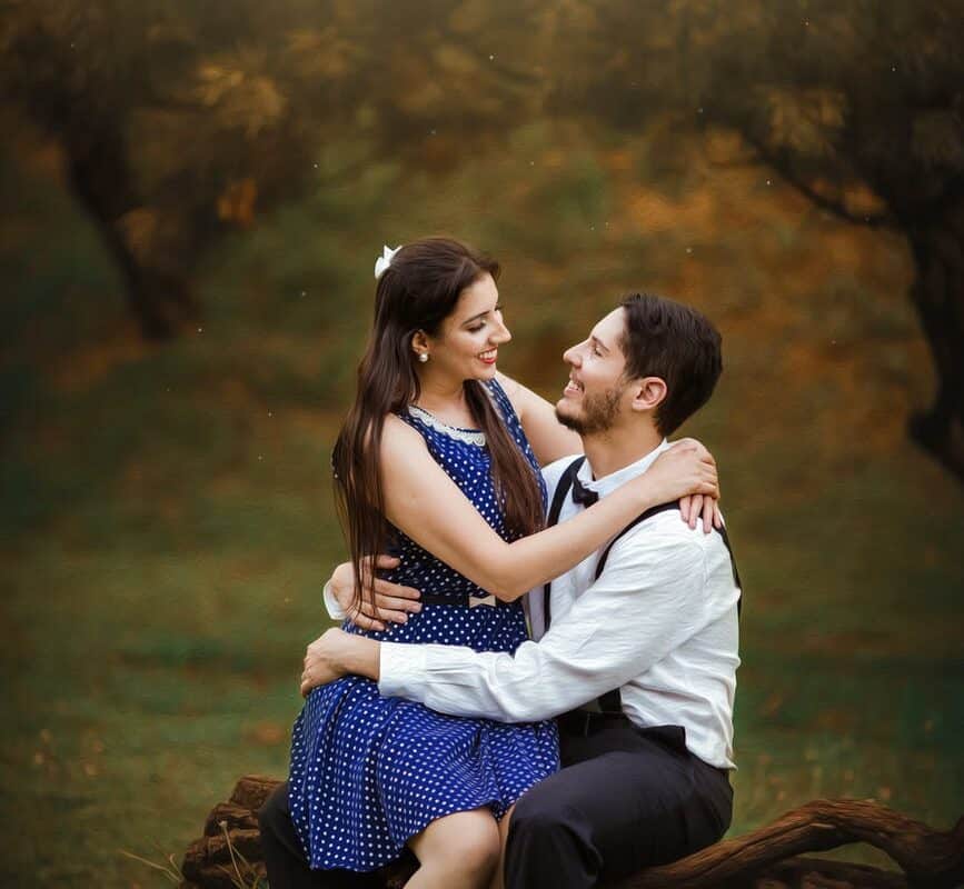 girl wearing blue dress sitting on man s lap