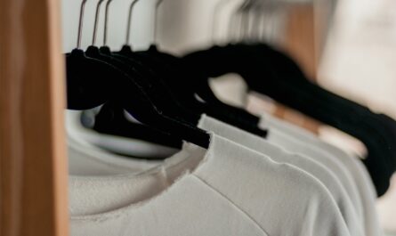 hanged white shirts on black clothes hangers