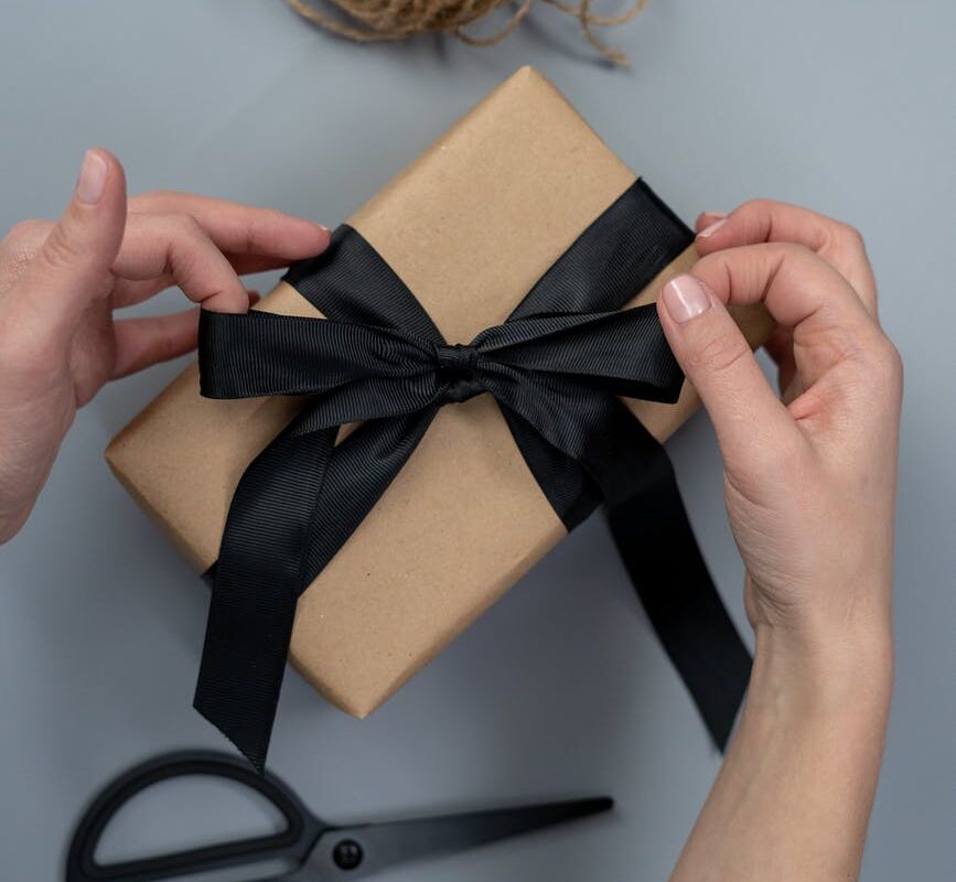 brown gift box with black ribbon