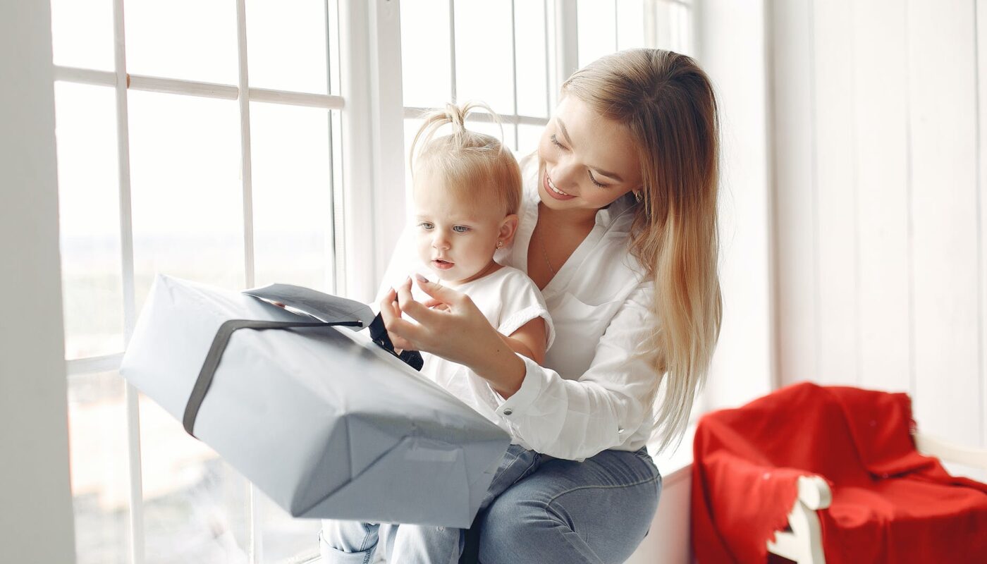 mother and daughter holding a gift