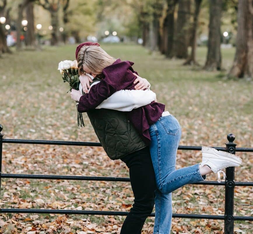 happy couple embracing in park
