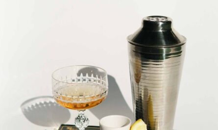 glass of liquor with coffee near shaker