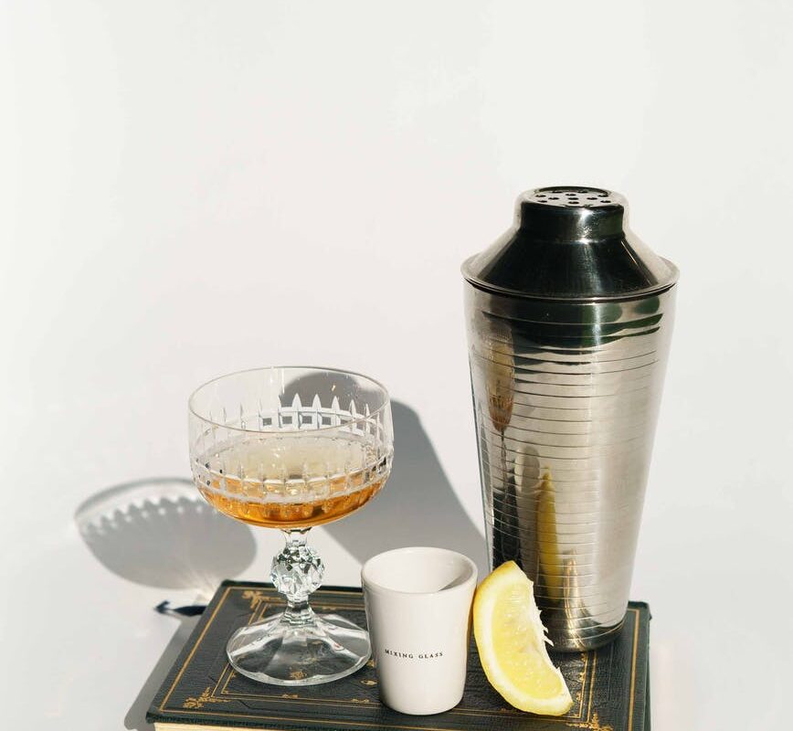 glass of liquor with coffee near shaker