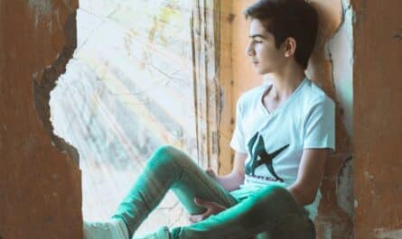 boy sitting near wall