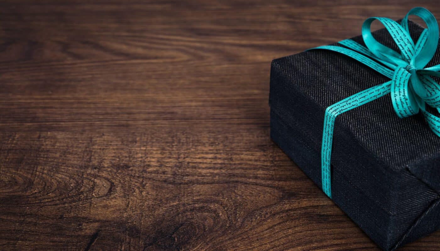 black gift box on wooden surface