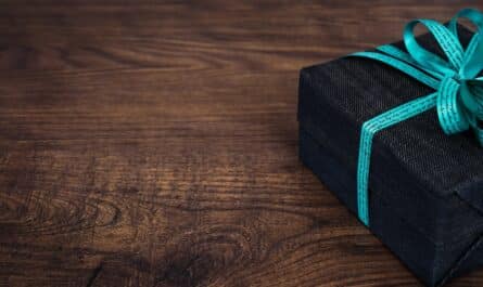 black gift box on wooden surface