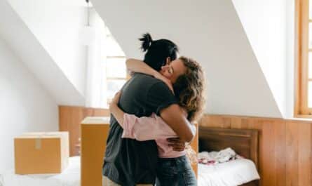 happy couple hugging after moving in new apartment