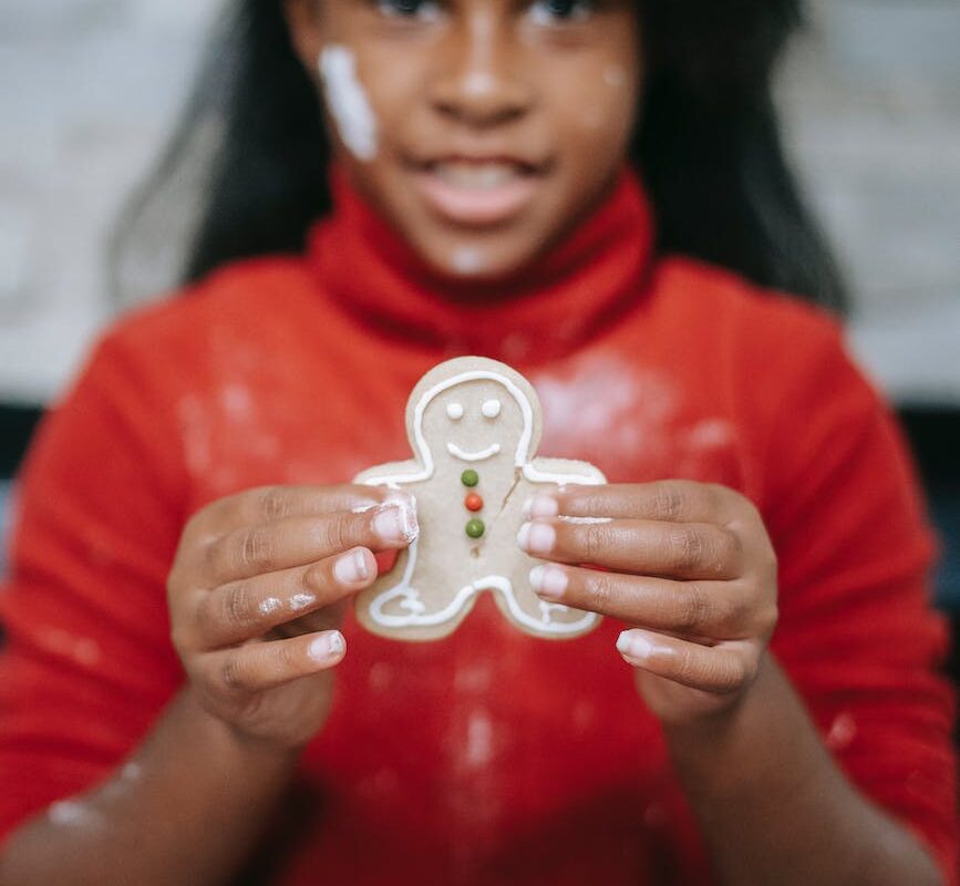 cute black girl showing homemade gingerbread man