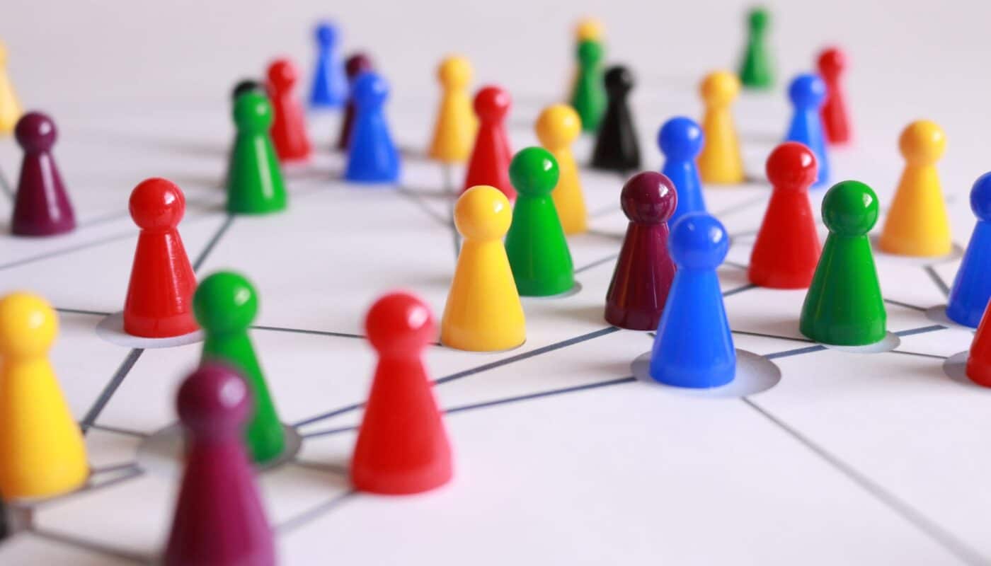 close up photography of yellow green red and brown plastic cones on white lined surface